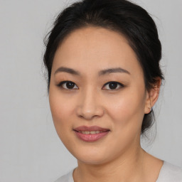 Joyful asian young-adult female with medium  black hair and brown eyes