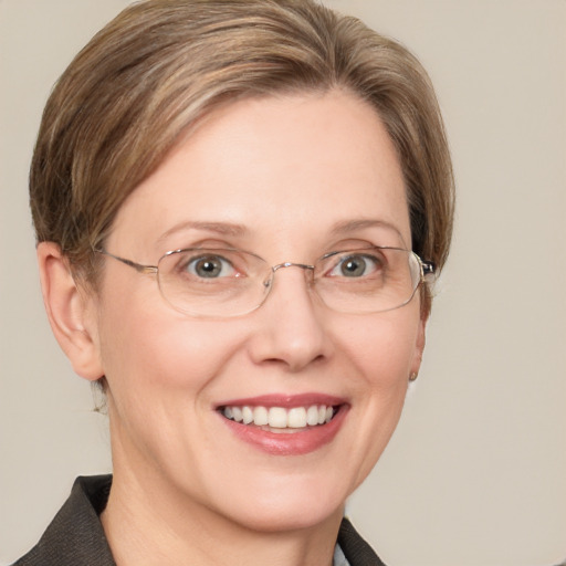 Joyful white adult female with medium  brown hair and blue eyes