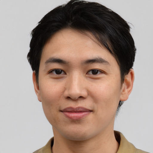 Joyful asian young-adult male with short  black hair and brown eyes