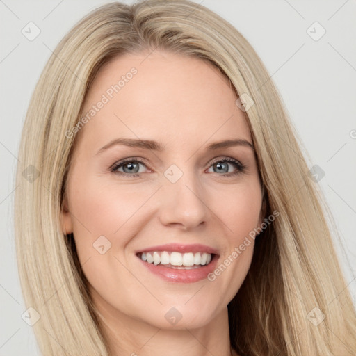 Joyful white young-adult female with long  brown hair and blue eyes