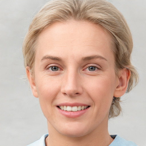 Joyful white young-adult female with medium  brown hair and blue eyes