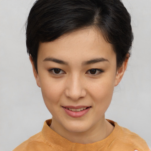 Joyful asian young-adult female with short  brown hair and brown eyes