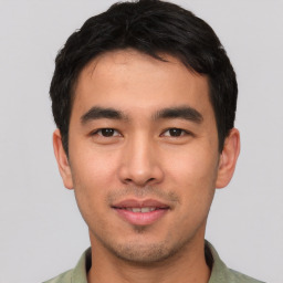 Joyful asian young-adult male with short  black hair and brown eyes