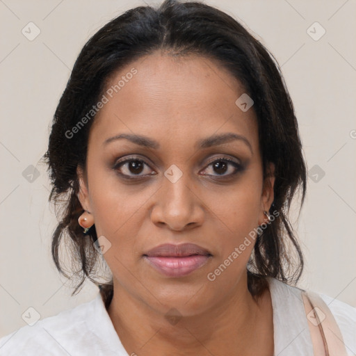 Joyful black adult female with medium  brown hair and brown eyes