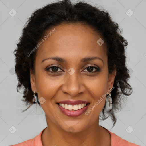 Joyful black adult female with medium  brown hair and brown eyes