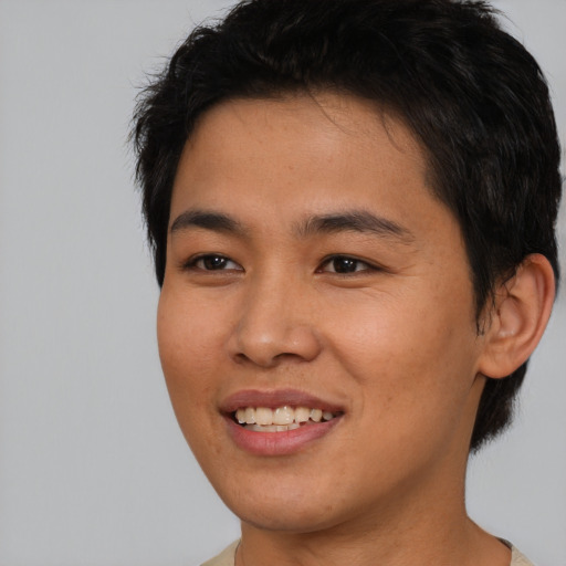 Joyful asian young-adult male with short  black hair and brown eyes