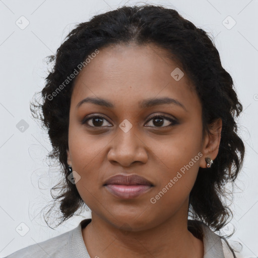 Joyful black young-adult female with long  black hair and brown eyes