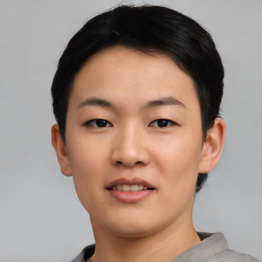 Joyful asian young-adult female with short  black hair and brown eyes