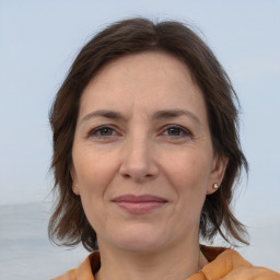 Joyful white adult female with medium  brown hair and brown eyes