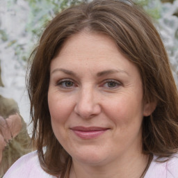 Joyful white adult female with medium  brown hair and brown eyes