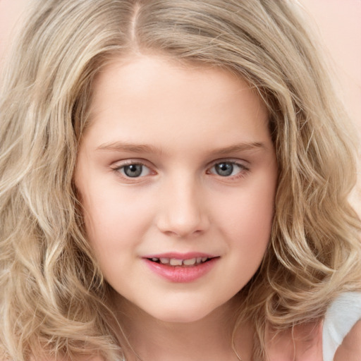 Joyful white child female with long  blond hair and green eyes