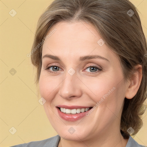 Joyful white adult female with medium  brown hair and brown eyes