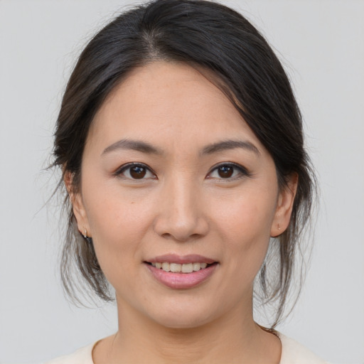 Joyful asian young-adult female with medium  brown hair and brown eyes