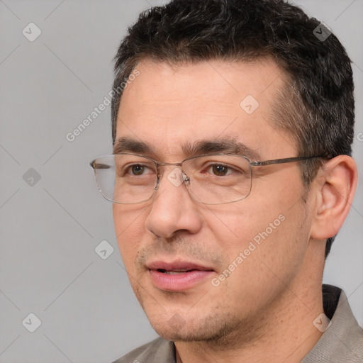 Joyful white adult male with short  black hair and brown eyes