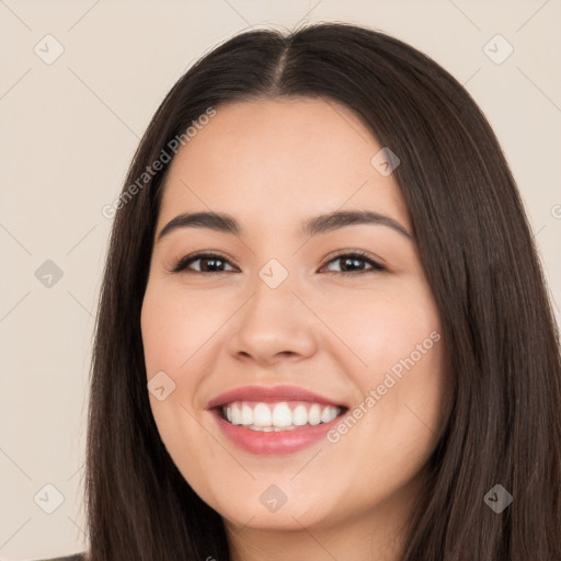 Joyful white young-adult female with long  brown hair and brown eyes