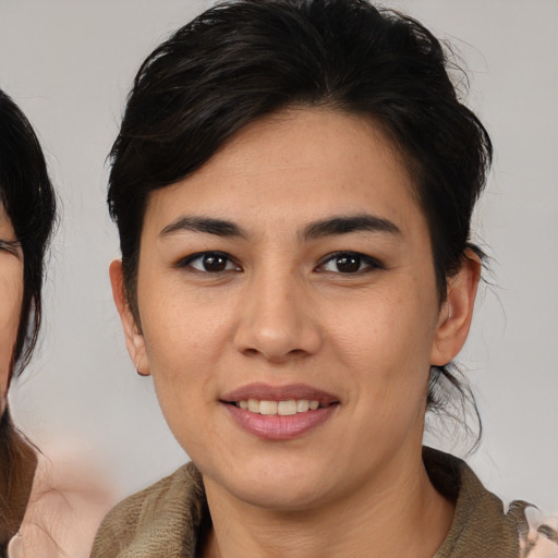 Joyful asian young-adult female with medium  brown hair and brown eyes