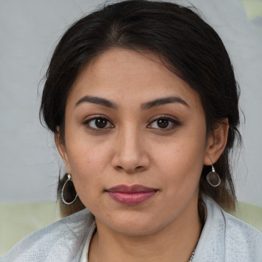 Joyful latino young-adult female with medium  brown hair and brown eyes