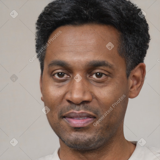 Joyful latino adult male with short  black hair and brown eyes