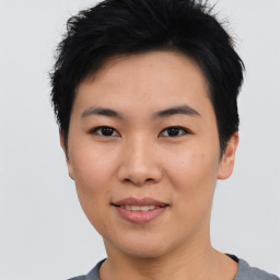 Joyful asian young-adult female with short  black hair and brown eyes