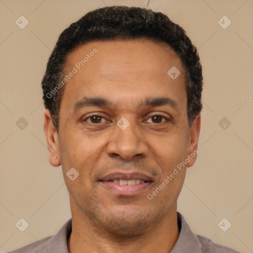 Joyful latino adult male with short  black hair and brown eyes