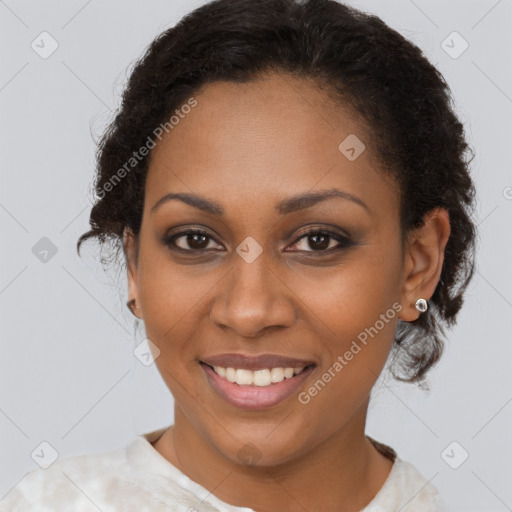 Joyful black young-adult female with short  brown hair and brown eyes