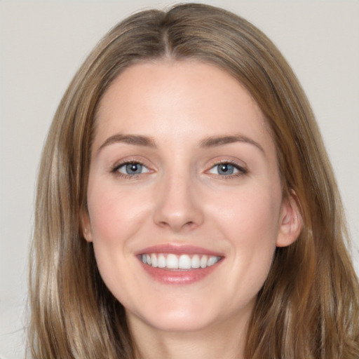 Joyful white young-adult female with long  brown hair and brown eyes