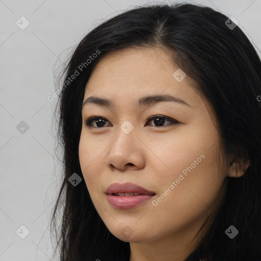 Joyful latino young-adult female with long  black hair and brown eyes