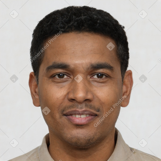 Joyful latino young-adult male with short  black hair and brown eyes