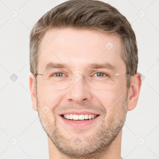 Joyful white adult male with short  brown hair and grey eyes