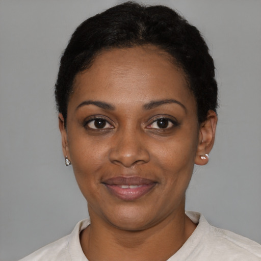Joyful black young-adult female with short  black hair and brown eyes