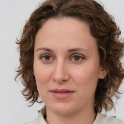 Joyful white young-adult female with medium  brown hair and green eyes