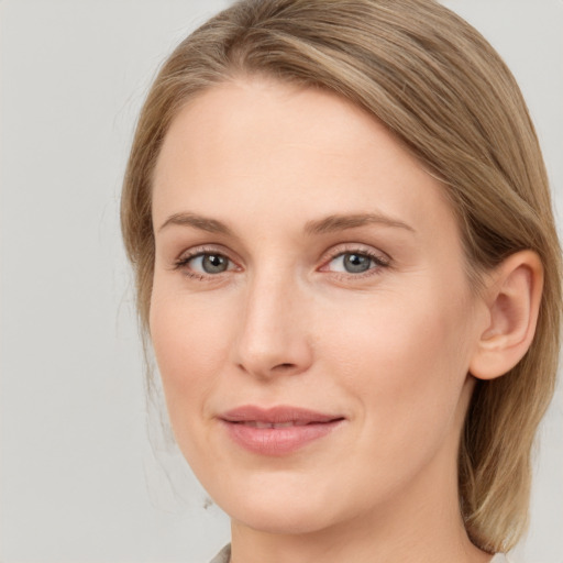 Joyful white young-adult female with medium  brown hair and blue eyes