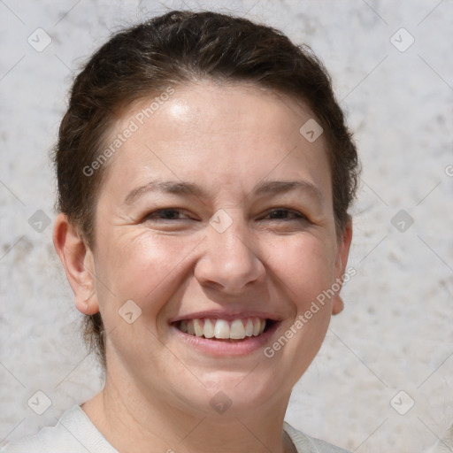 Joyful white adult female with short  brown hair and brown eyes