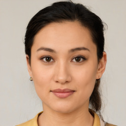 Joyful latino young-adult female with medium  brown hair and brown eyes