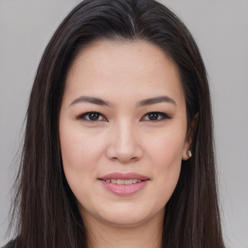 Joyful asian young-adult female with long  brown hair and brown eyes