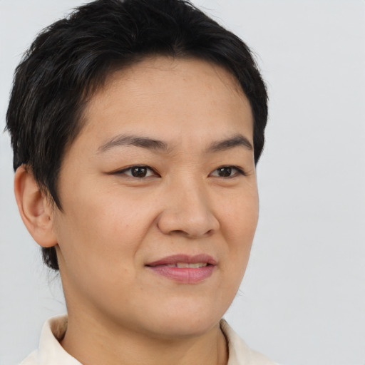 Joyful asian young-adult female with short  brown hair and brown eyes