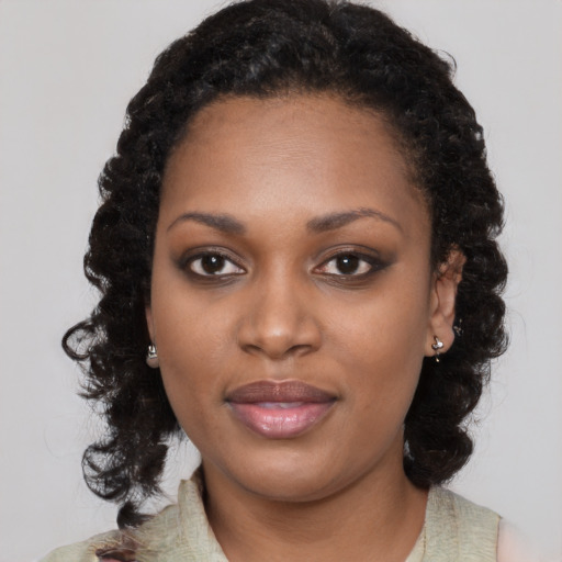 Joyful black young-adult female with medium  black hair and brown eyes