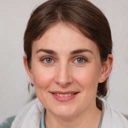 Joyful white young-adult female with medium  brown hair and blue eyes