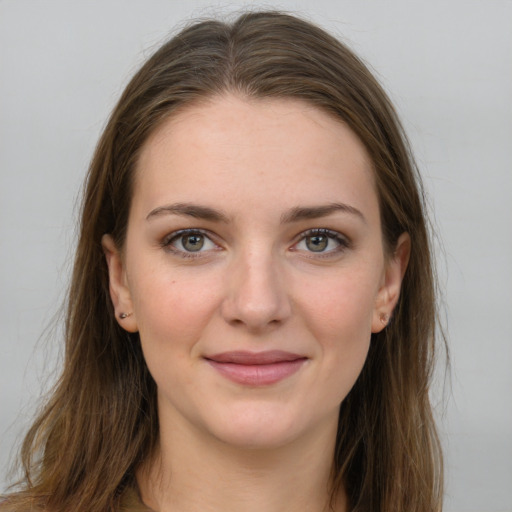 Joyful white young-adult female with long  brown hair and grey eyes