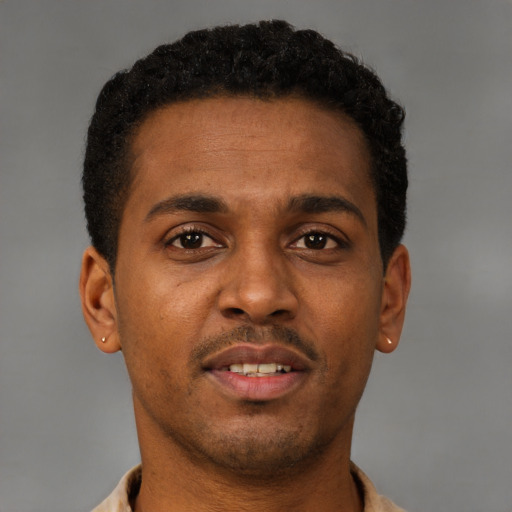 Joyful latino young-adult male with short  brown hair and brown eyes
