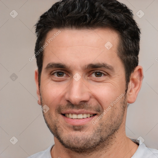 Joyful white young-adult male with short  black hair and brown eyes