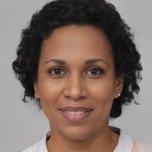 Joyful black adult female with short  black hair and brown eyes