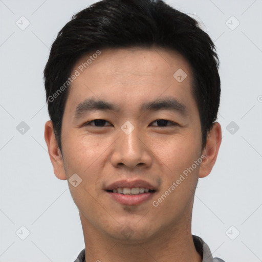 Joyful asian young-adult male with short  black hair and brown eyes