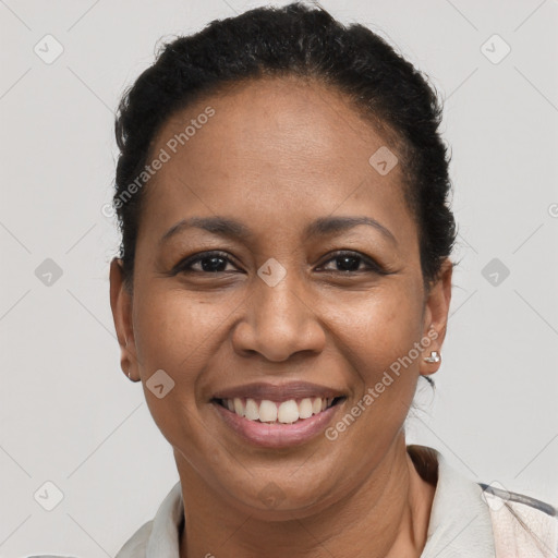 Joyful black adult female with short  brown hair and brown eyes