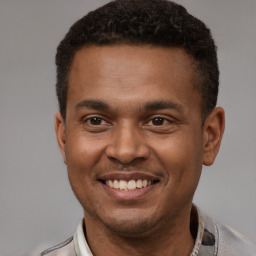 Joyful latino young-adult male with short  brown hair and brown eyes