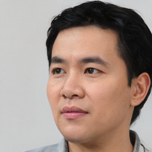 Neutral asian young-adult male with short  black hair and brown eyes