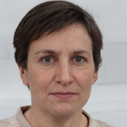 Joyful white adult female with short  brown hair and brown eyes