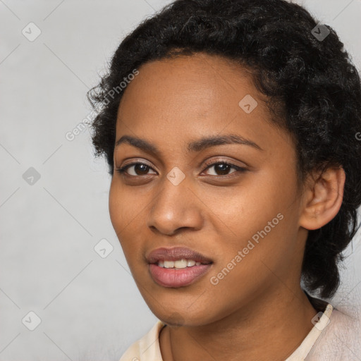 Joyful black young-adult female with short  black hair and brown eyes