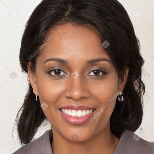 Joyful black young-adult female with long  brown hair and brown eyes