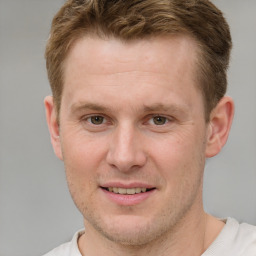 Joyful white adult male with short  brown hair and grey eyes